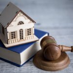 house model on book with judge